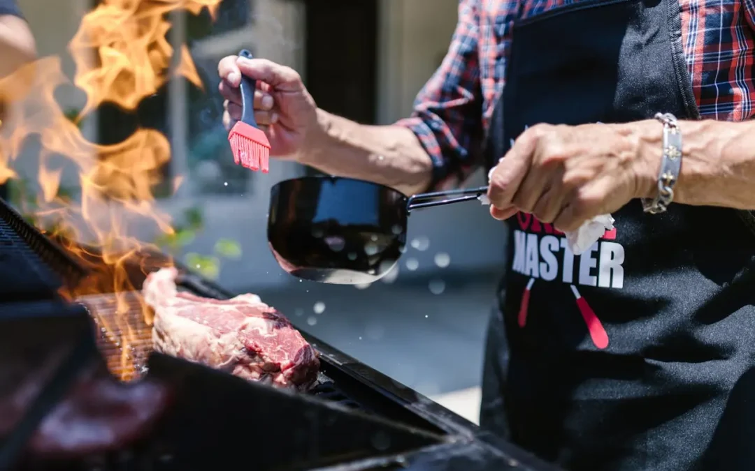 man grilling steaks on a gas barbecue